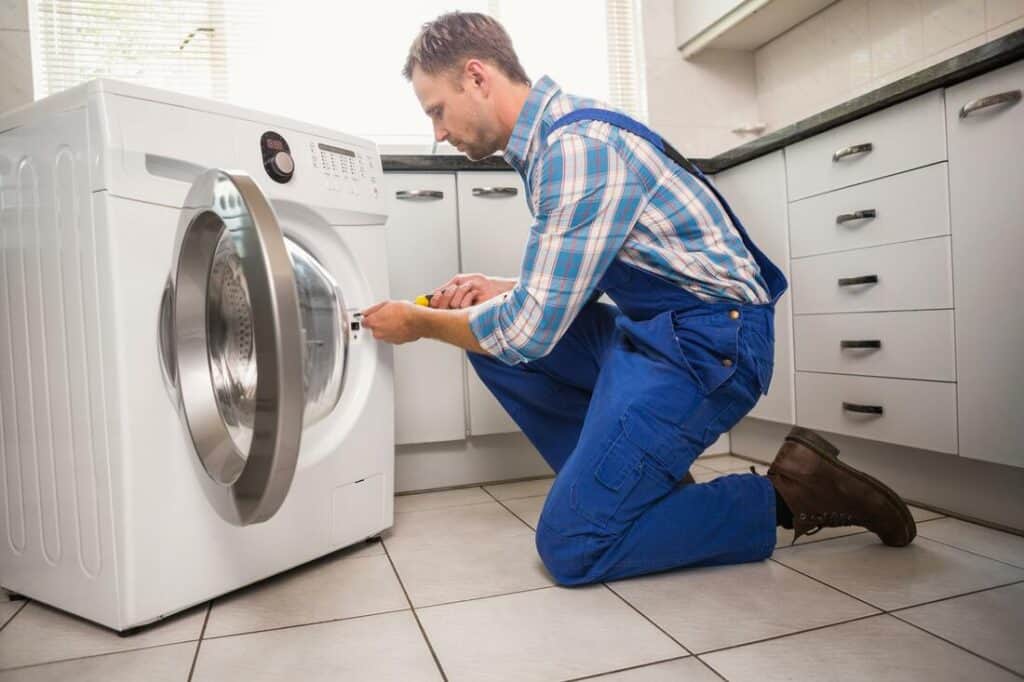 Repairman Fixing Washing Machine